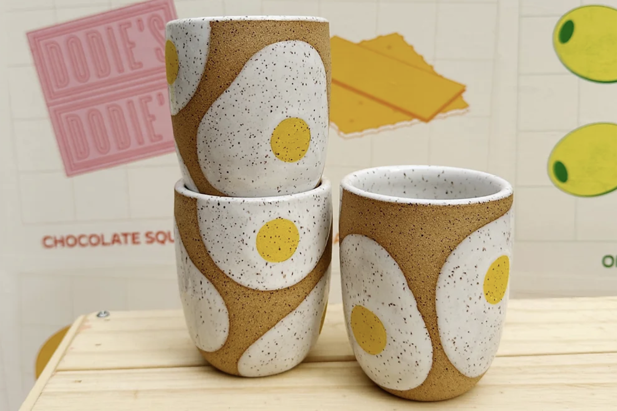three tumbler cups with sunny side up eggs on them