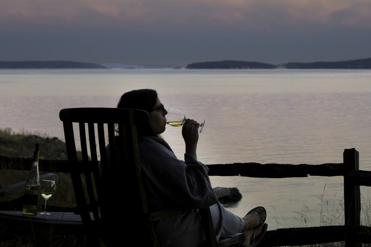 woman drinking wine while vacationing at one of the most romantic getaways in the Pacific Northwest