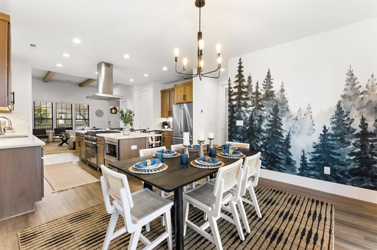 living room with wallpaper covered in evergreen trees