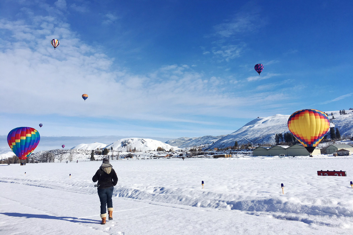 Woman at a hot air balloon festival at one of the best winter getaways in Washington state