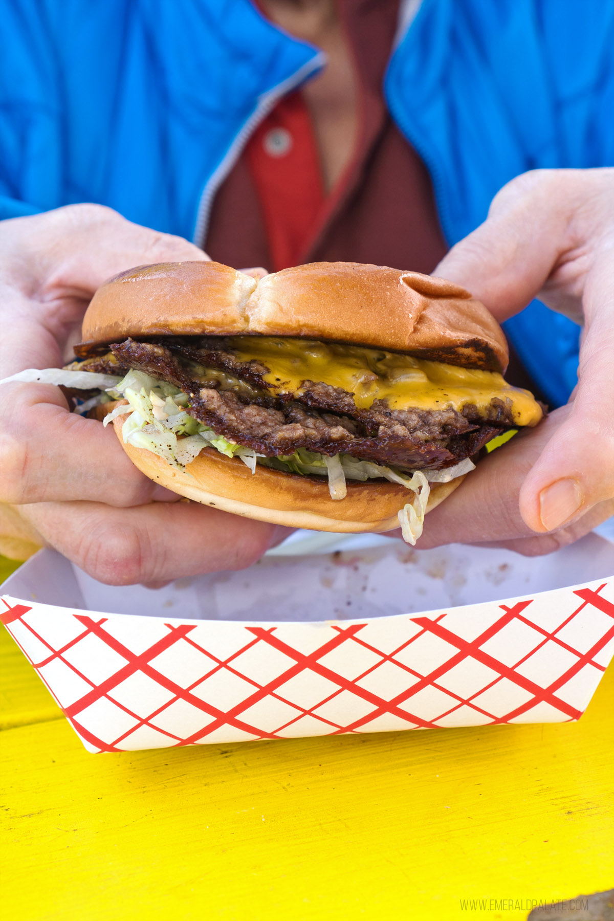 person holding a smash burger from where to eat in Bend Oregon