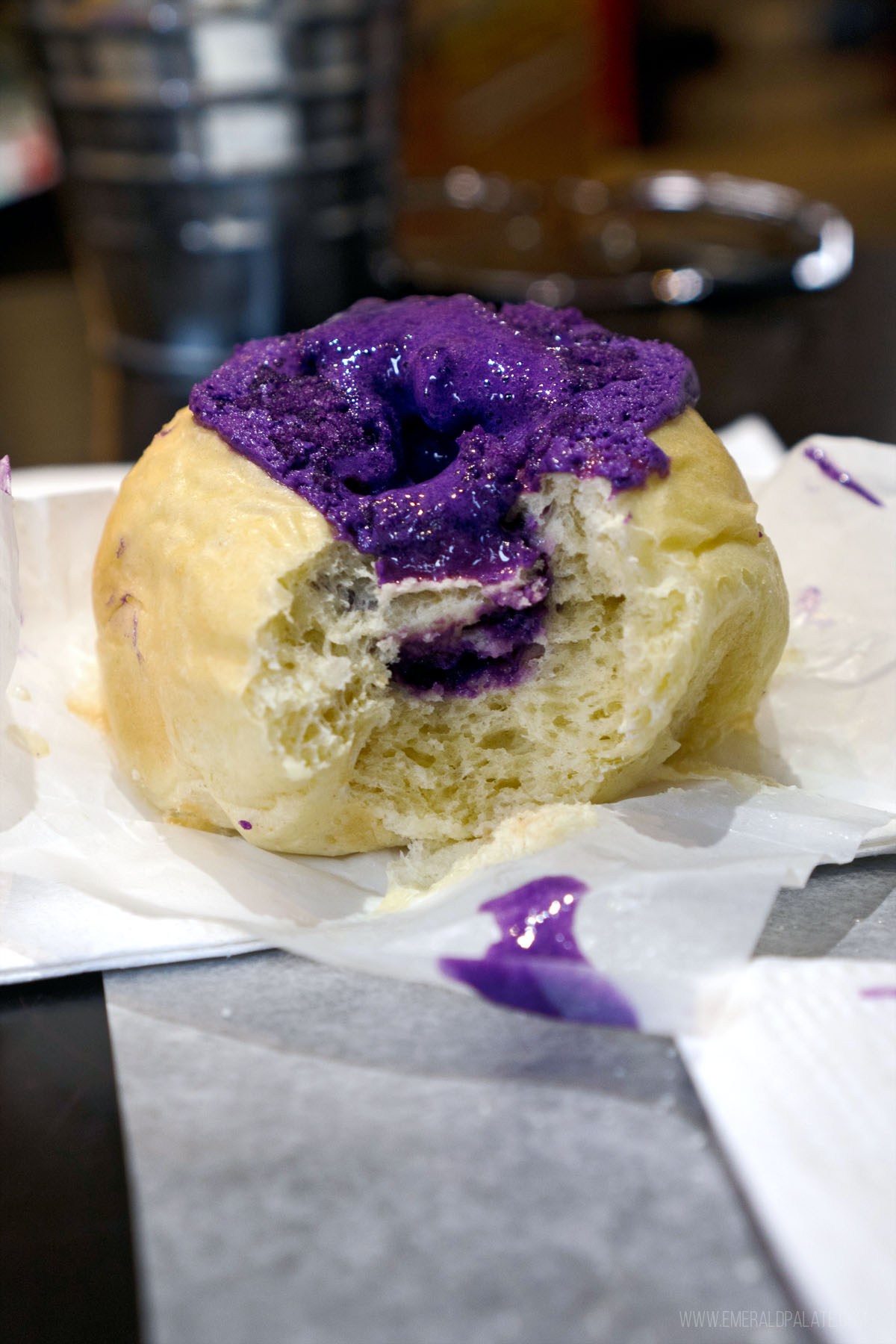 pastry with a bite taken out and oozing ube cream