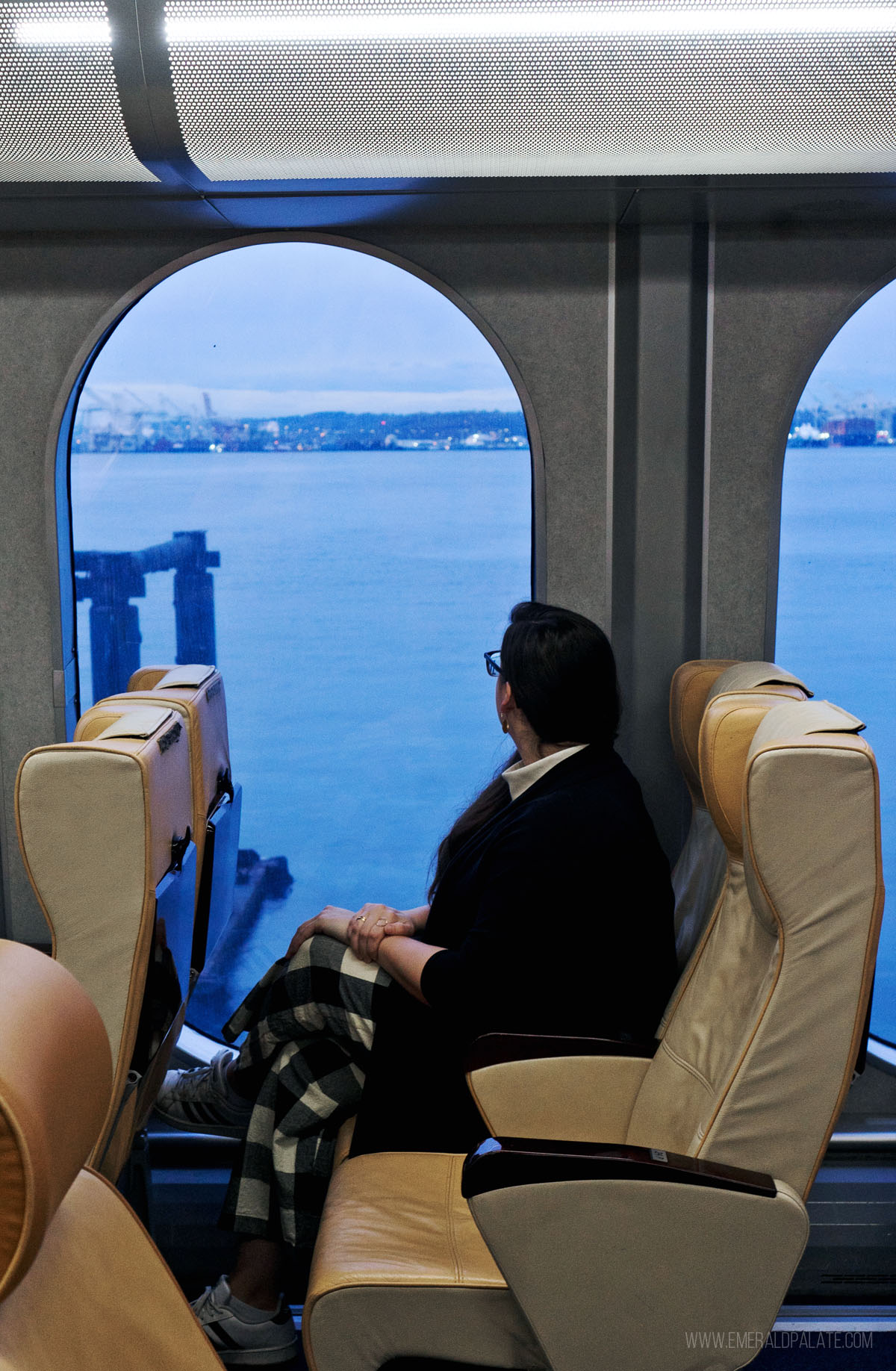 woman looking out the window on the Clipper ferry, one of the most unique things to do in Victoria BC