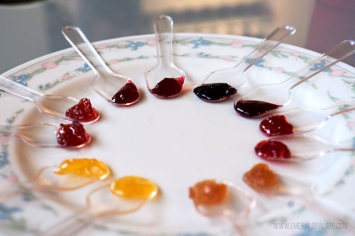 spoons lined with colorful jam on a plate