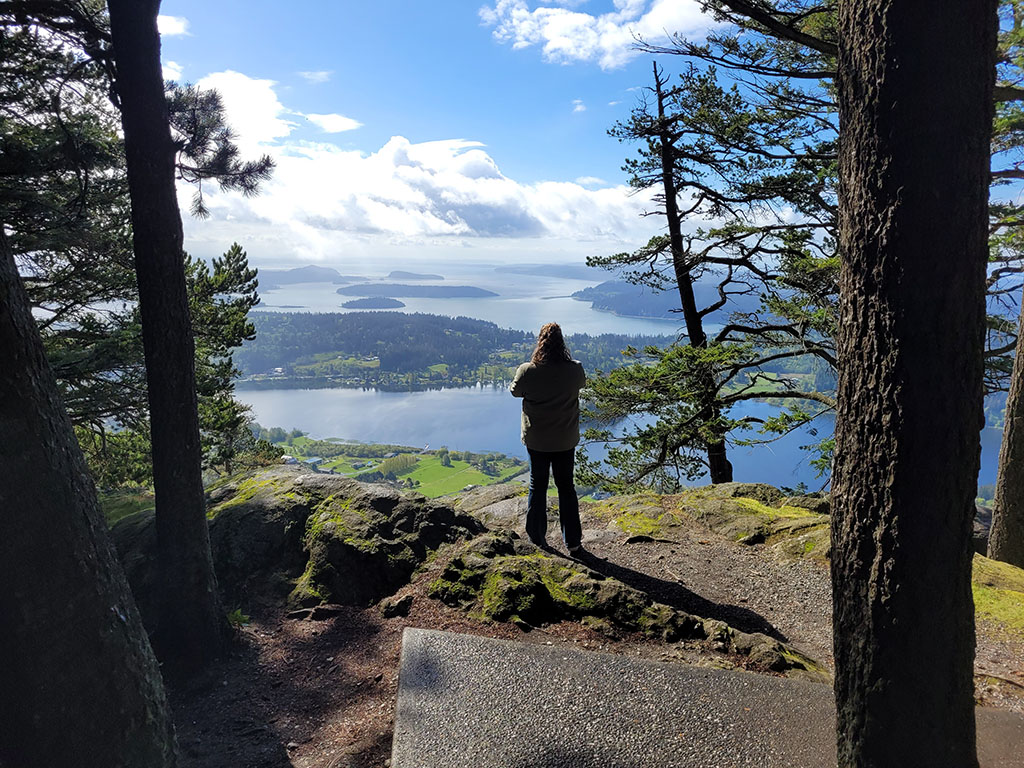 Travel planning client taking a picture over a pretty vista