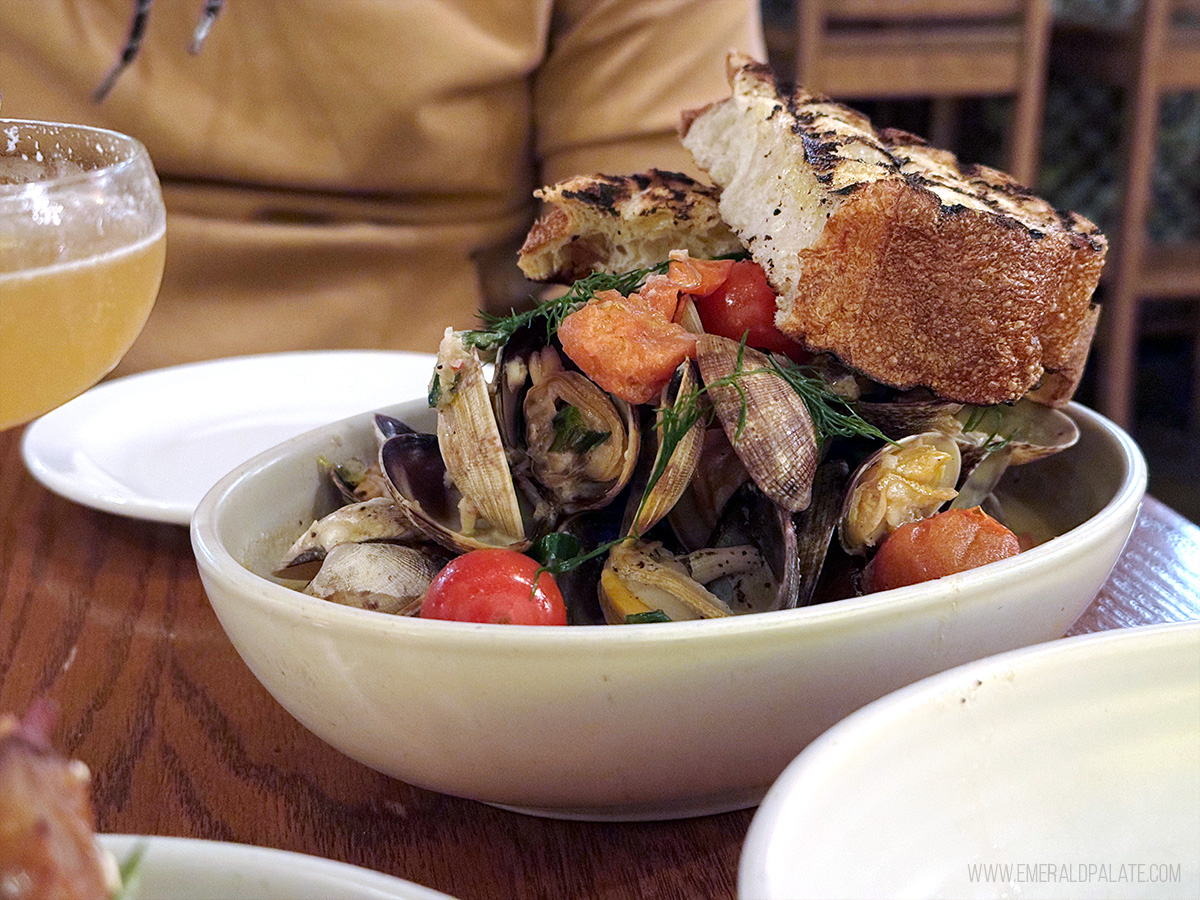 bowl of clams and grilled bread at one of the hidden gem restaurants in Victoria BC