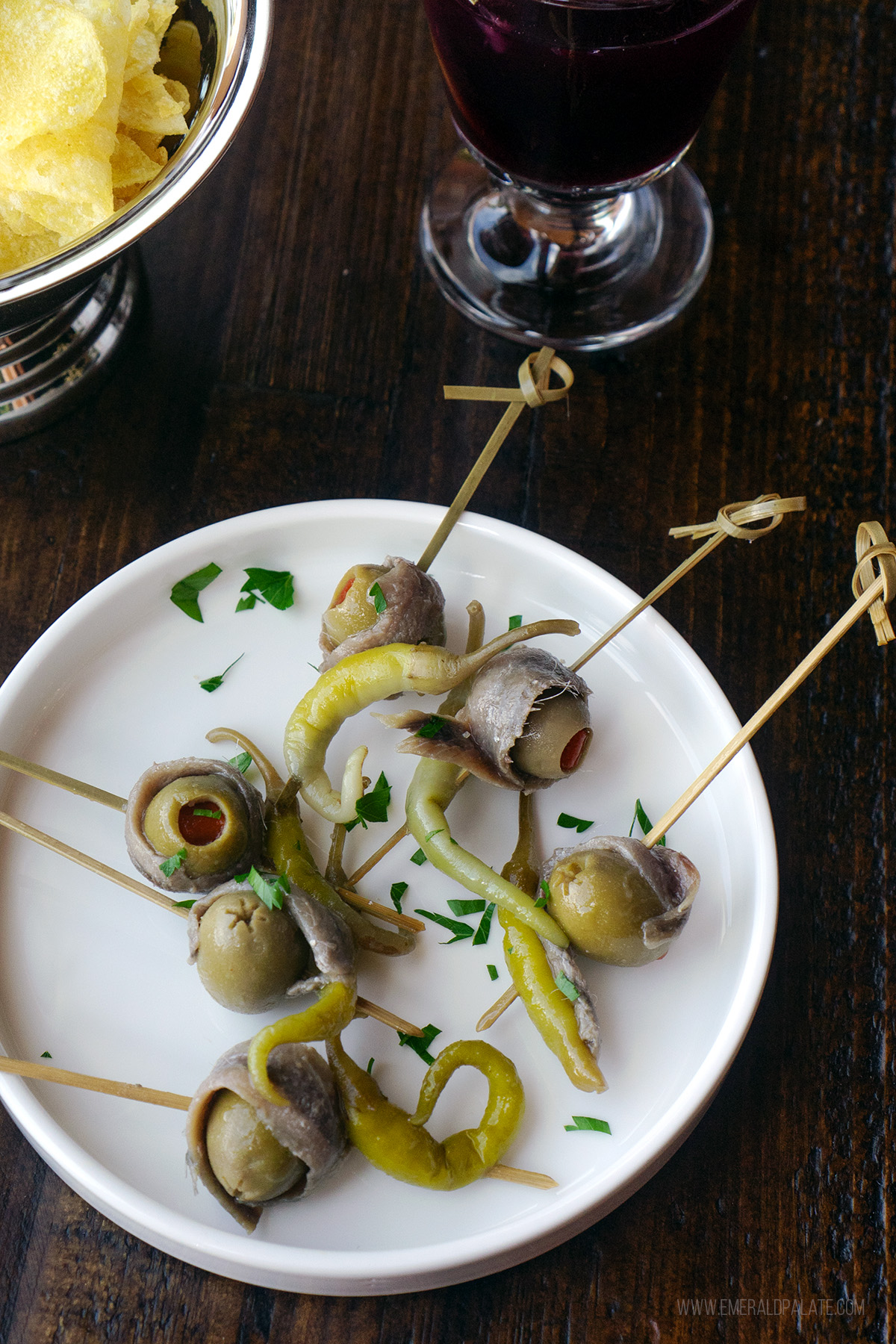 plate of olives and anchovy skewers