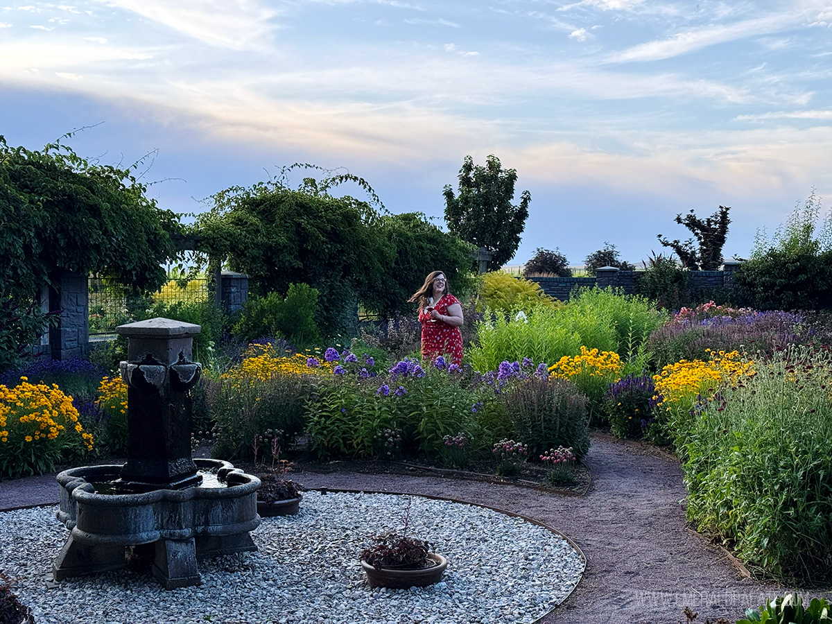 woman walking through the gardens at Abeja Winery, one of the best wineries in Walla Walla