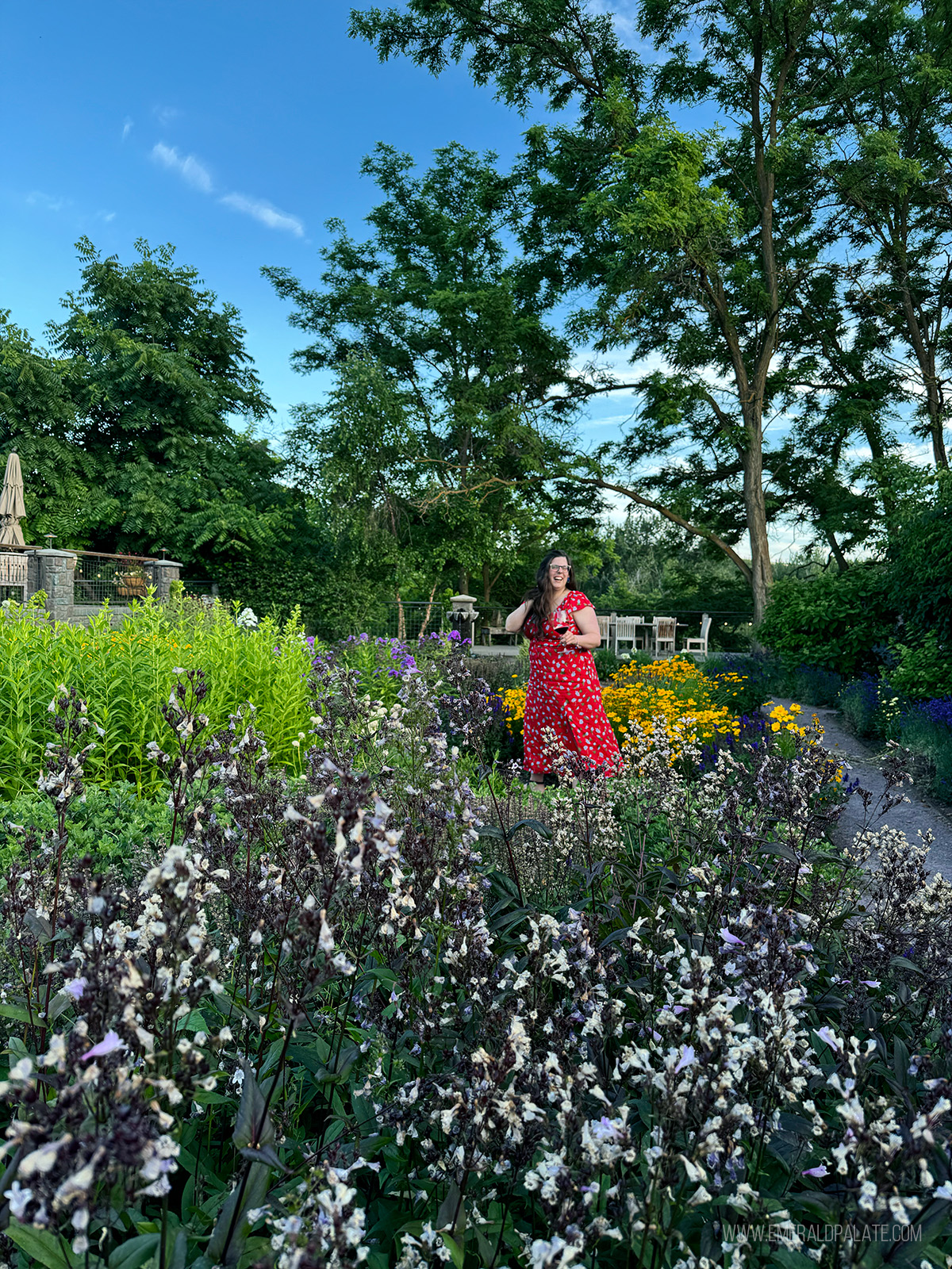 woman walking through a garden at one of the best wineries in Walla Walla