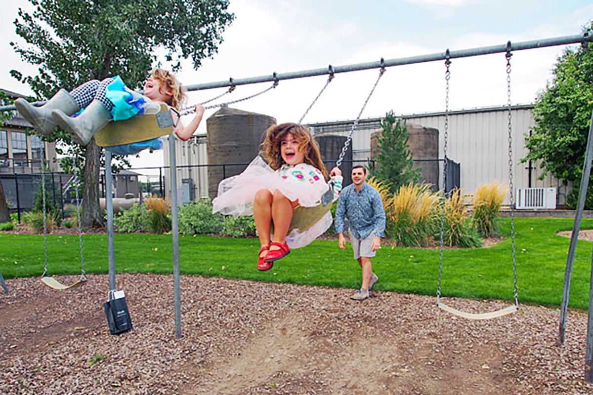 Seattle with kids Kids being pushed on a swing, one of the best things to do in Seattle with kids