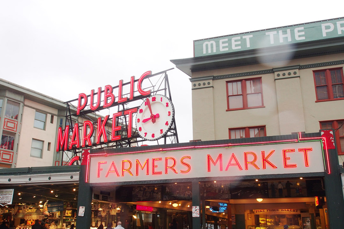 Neon sign welcoming people to Pike Place Market: What to Do at Pike Place Market