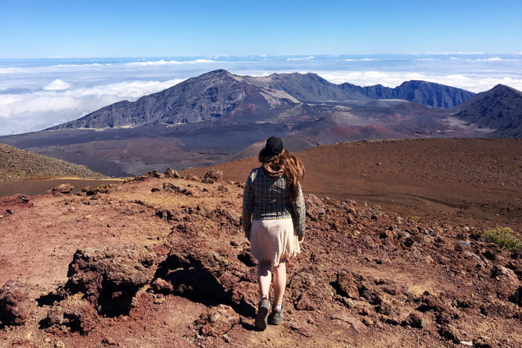 Woman walking along Haleakala summit, one of the best things to do in Maui Hawaii