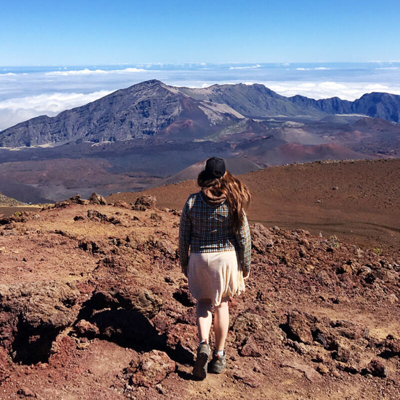 Woman walking along Haleakala summit, one of the best things to do in Maui Hawaii