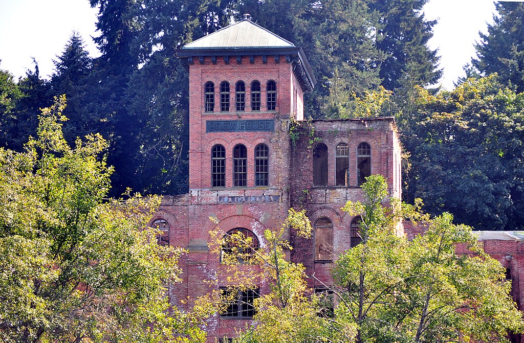 Old Olympia Brewery brick building peaking out through the trees