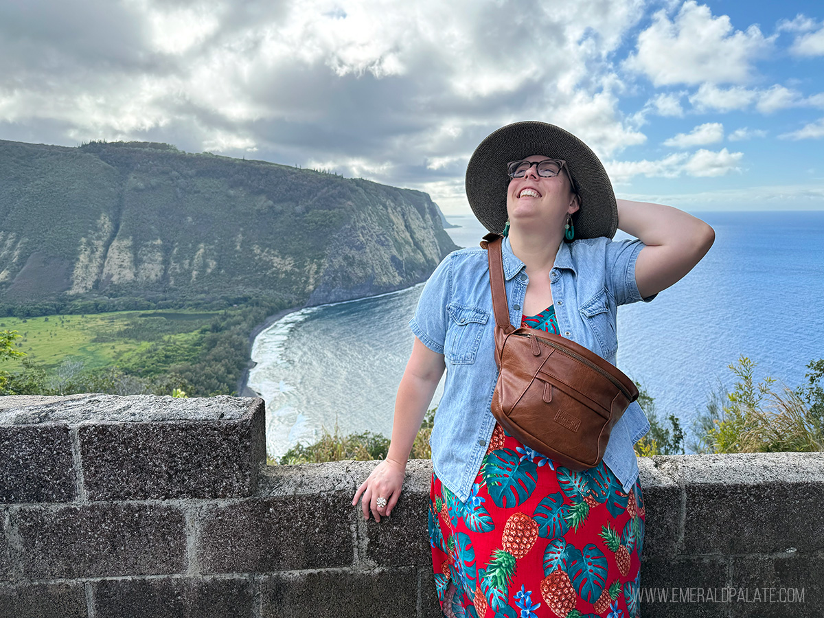 woman posing at a viewpoint of Waipio Valley, one of the best things to do on the Big Island in Hawaii