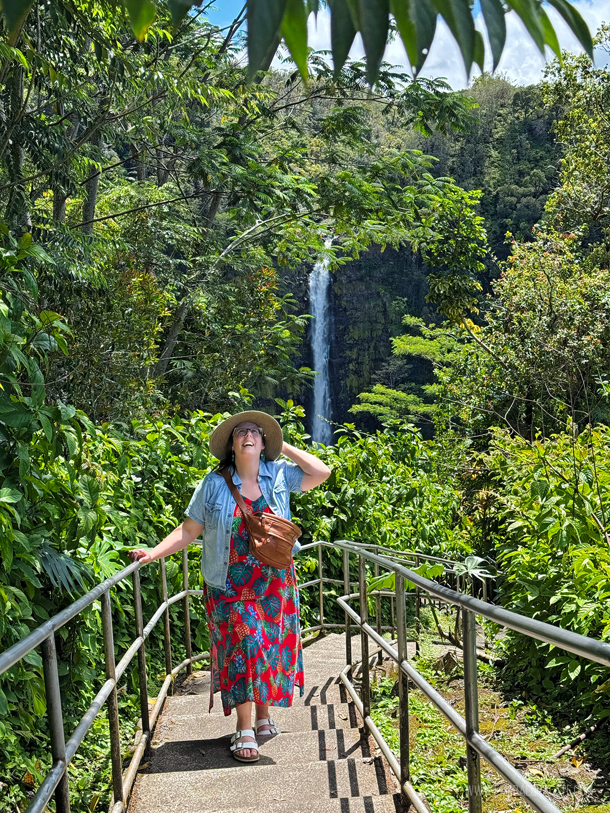 woman posing in front of Akaka Falls, one of the best things to do on the Big Island in Hawaii