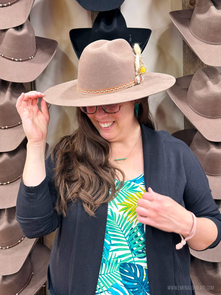 woman laughing while modeling a custom made cowboy hat, one of the best things to do in Scottsdale, Arizona
