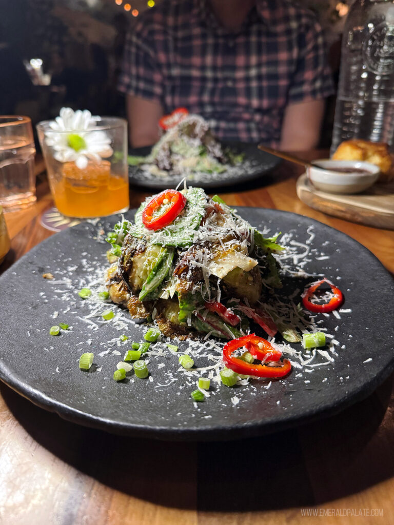 Brussel sprout salad covered with peppers and cheese