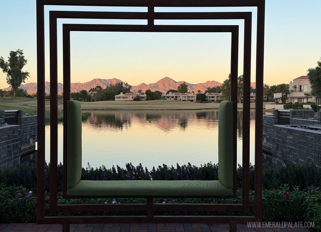 picturesque mountains in the distance at sunset framed by an art structure made to look like a picture frame