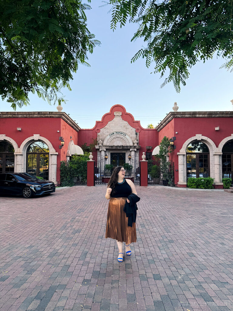 woman laughing in front of Cafe Monarch, one of the best restaurants in Scottsdale