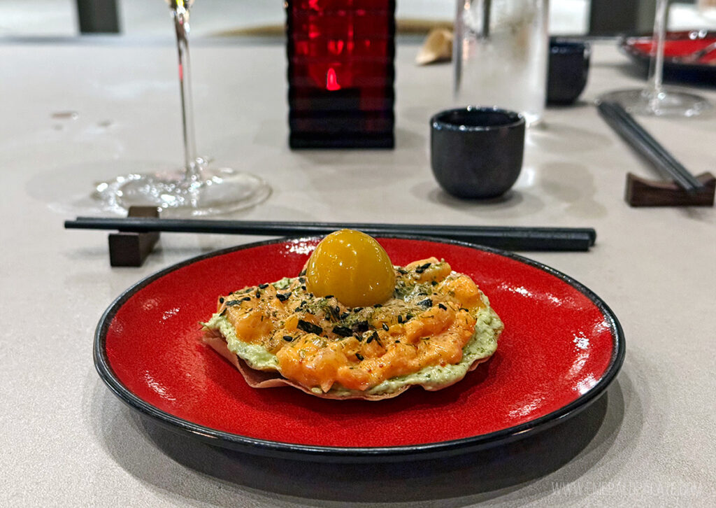 spicy tuna tostada with what looks like an egg yolk, but is mango