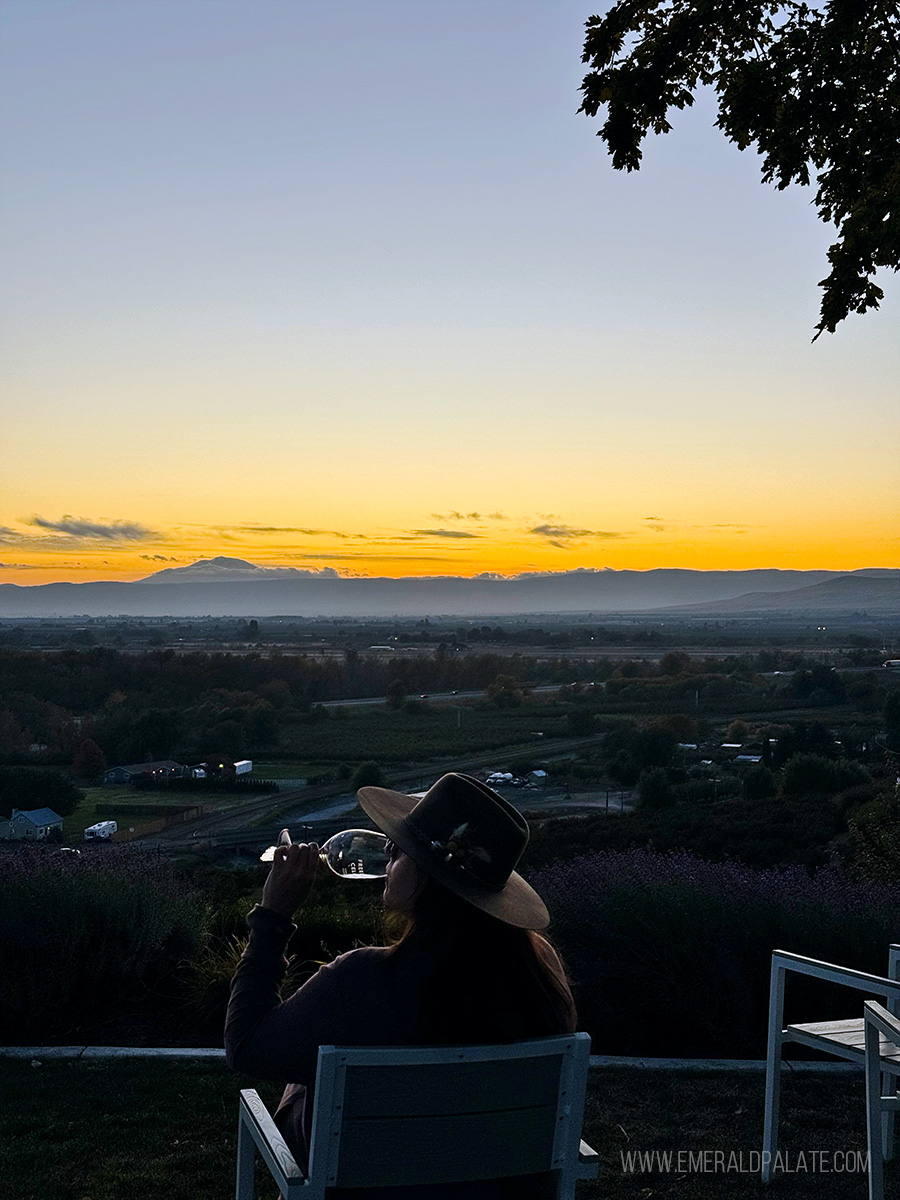 woman enjoying wine while soaking in the sunset at one of the best wineries in the Yakima Valley AVA