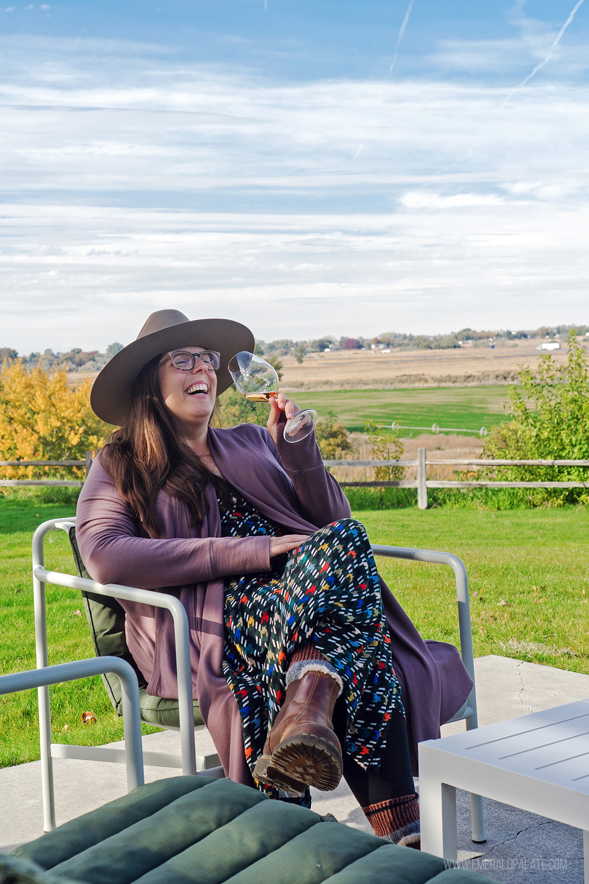 woman laughing while enjoying wine
