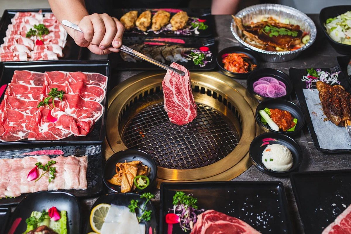person grilling meat at one of the best restaurants for birthdays in Seattle