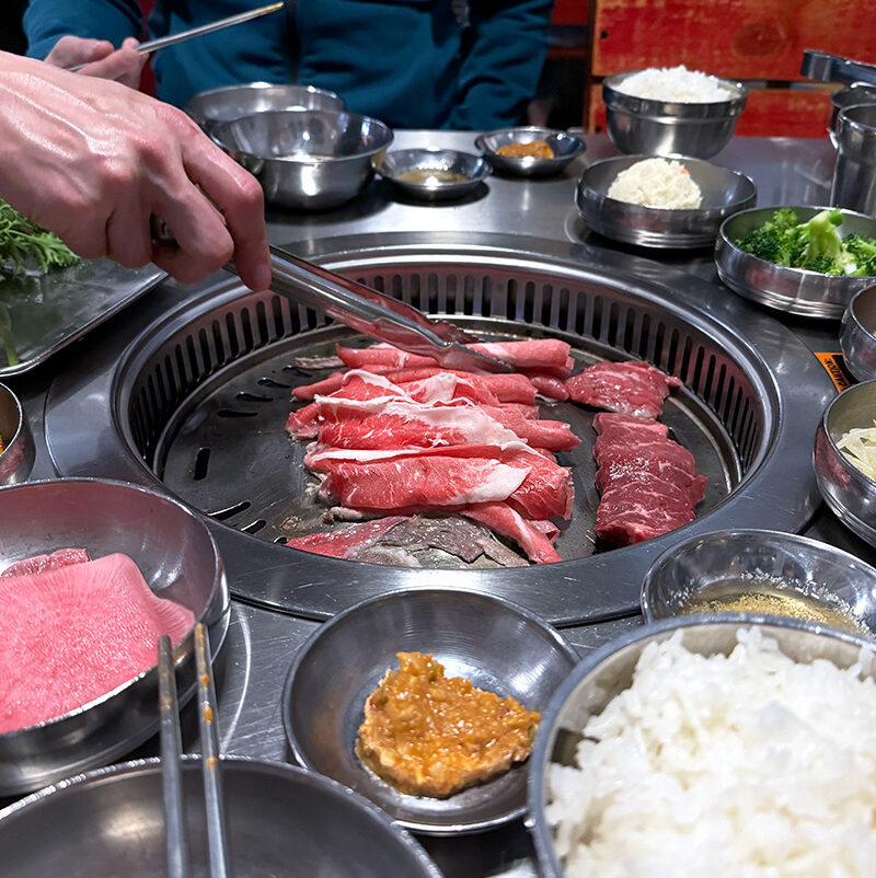 person grilling meets on a tabletop grill at Korean BBQ in Seattle, WA