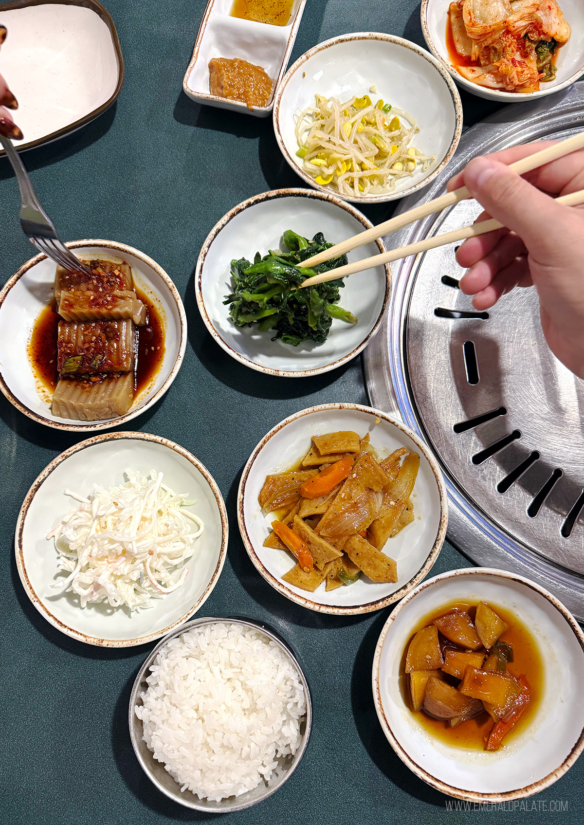 person picking up banchan with chopsticks at one of the best Korean BBQ in Seattle, WA