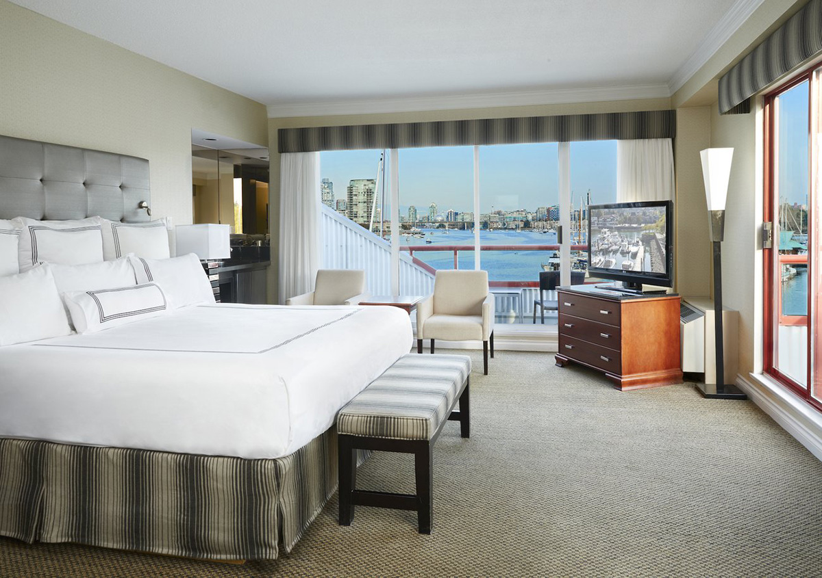 luxury hotel room with big windows overlooking Vancouver harbor