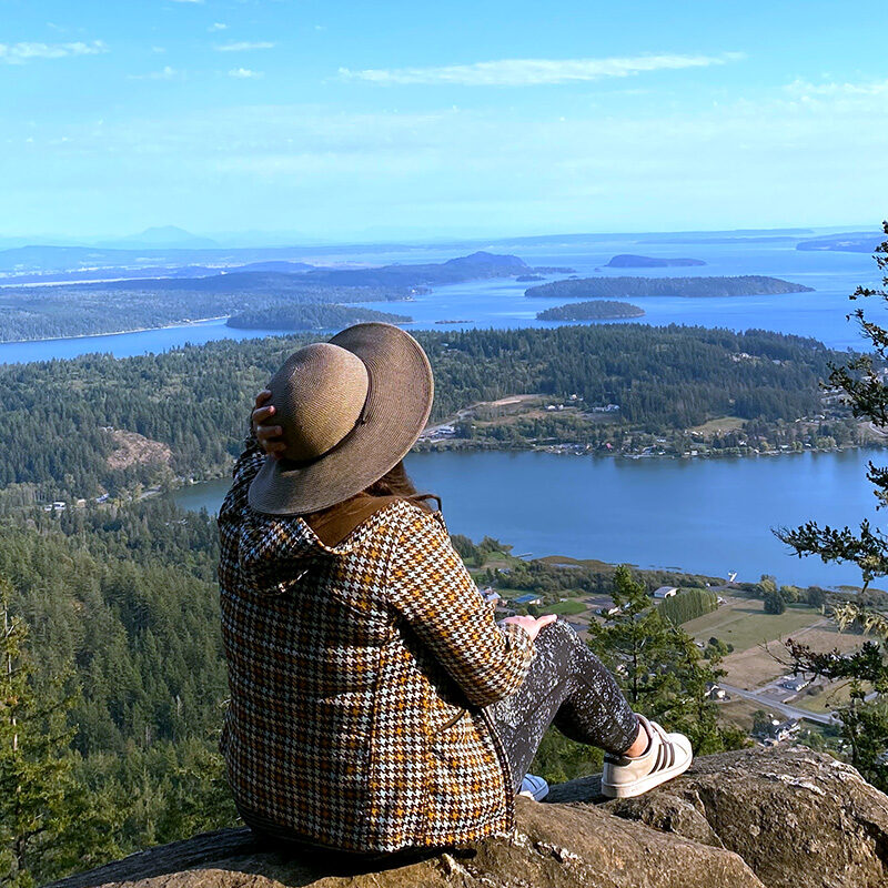 woman taking in the views from a viewpoint on her Seattle to Vancouver road trip