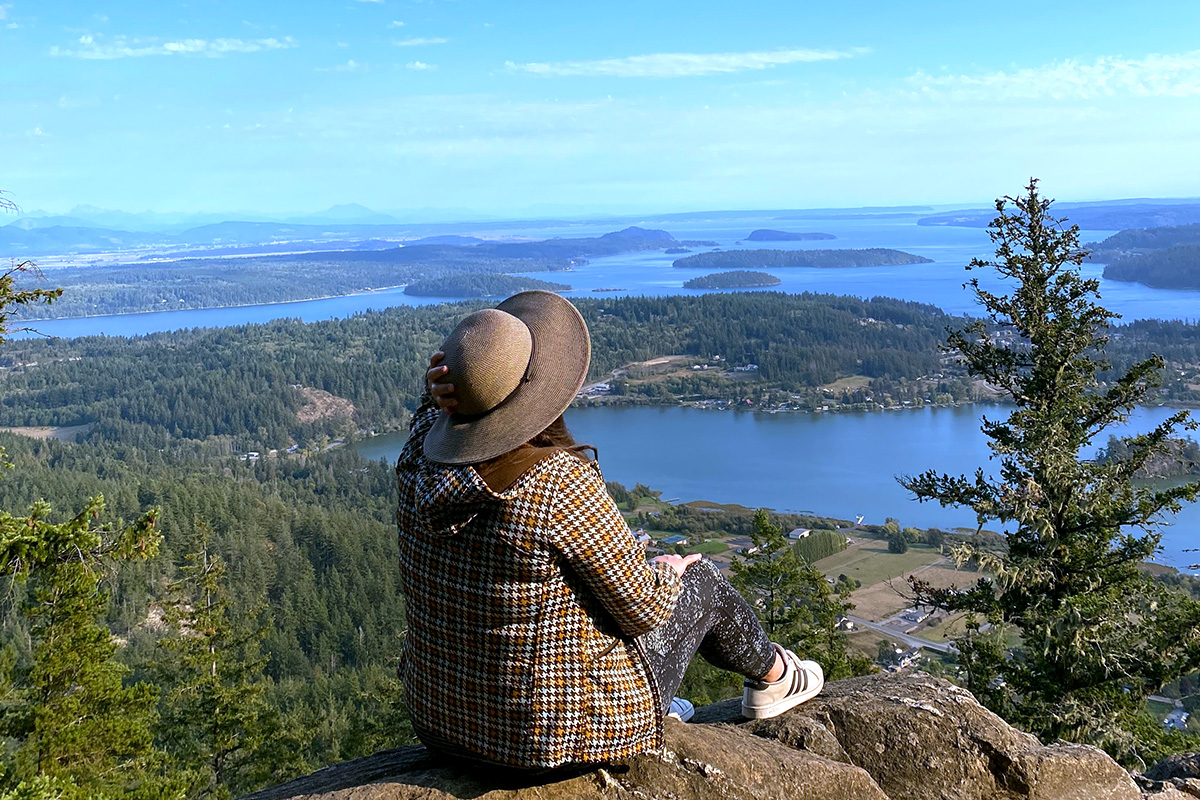 woman taking in the views from a viewpoint on her Seattle to Vancouver road trip