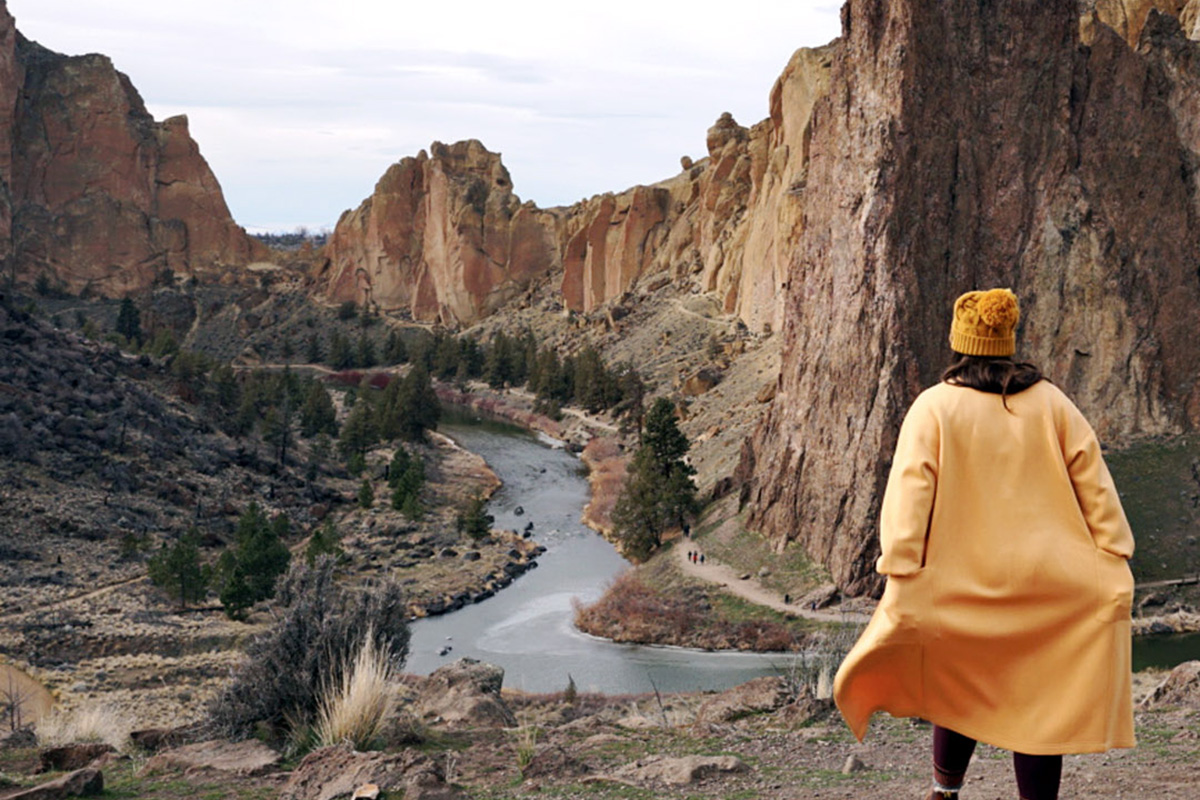 Smith Rock State Park woman running through Smith Rock State Park, one of the attractions near where to stay in Bend Oregon