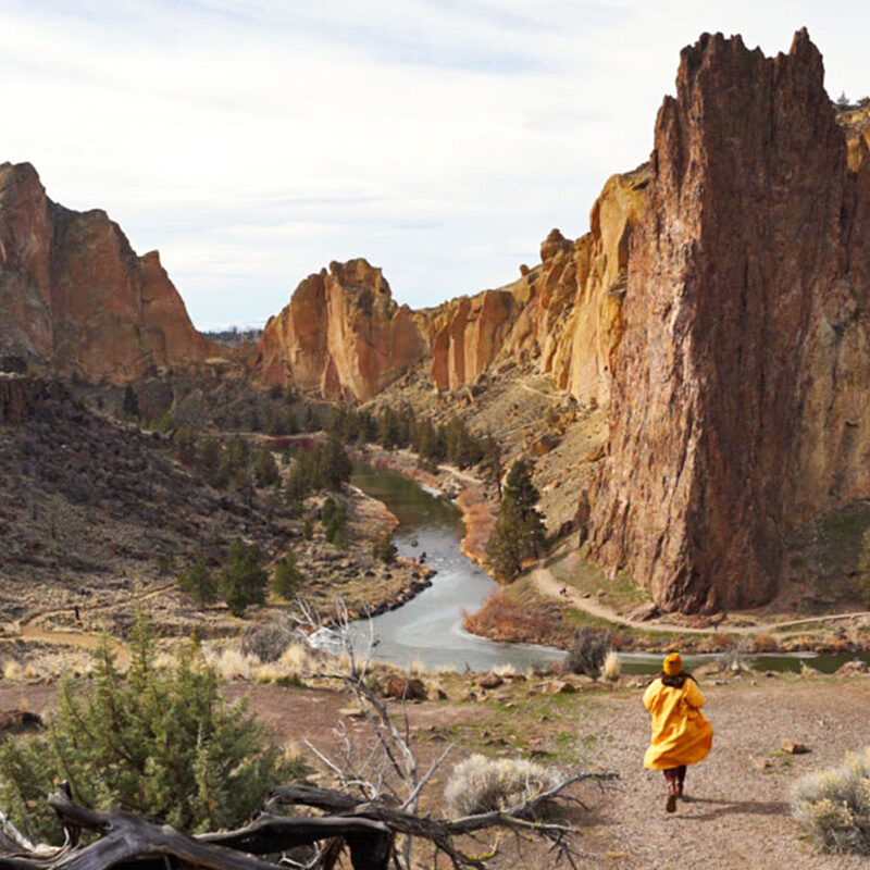 woman running through Smith Rock State Park, one of the attractions near where to stay in Bend Oregon