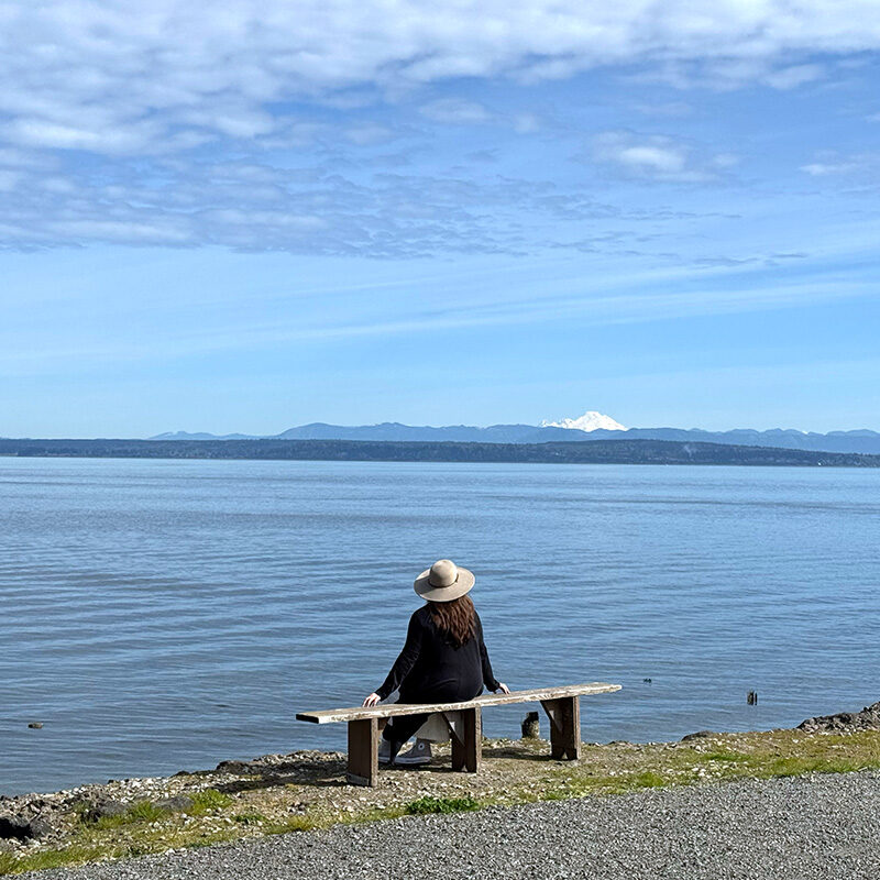 woman enjoying the view along the waterfront of Mukilteo, one of the best things to do in Snohomish