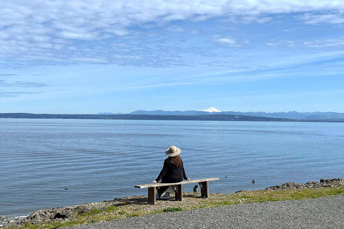 woman enjoying the view along the waterfront of Mukilteo, one of the best things to do in Snohomish