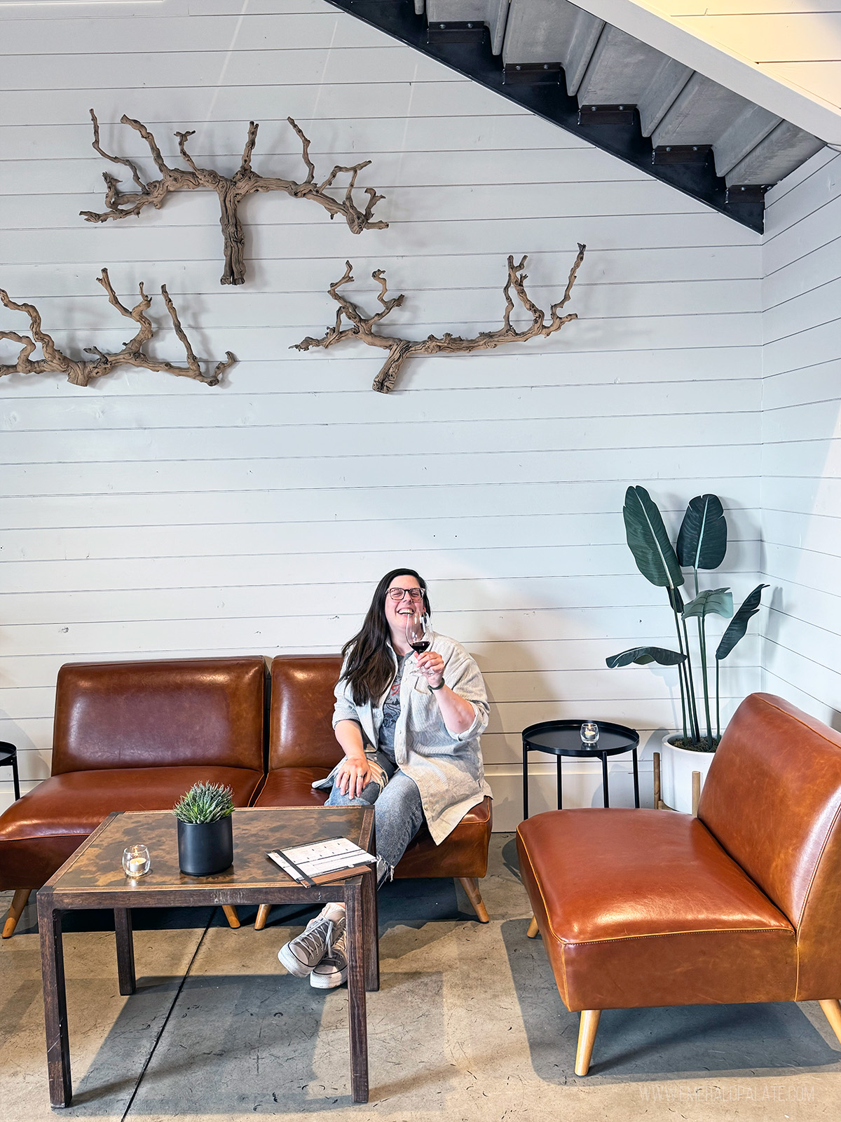 Woman laughing drinking wine in a tasting room, one of the best restaurants to do in Snohomish County