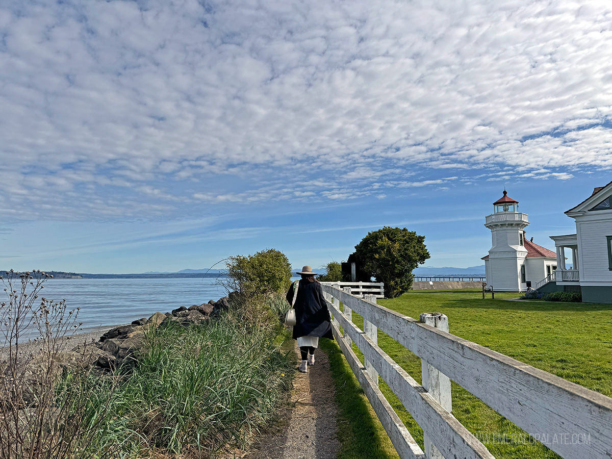 woman walking through Mukilteo Lighthouse Beach Park, one of the best things to do in Snohomish