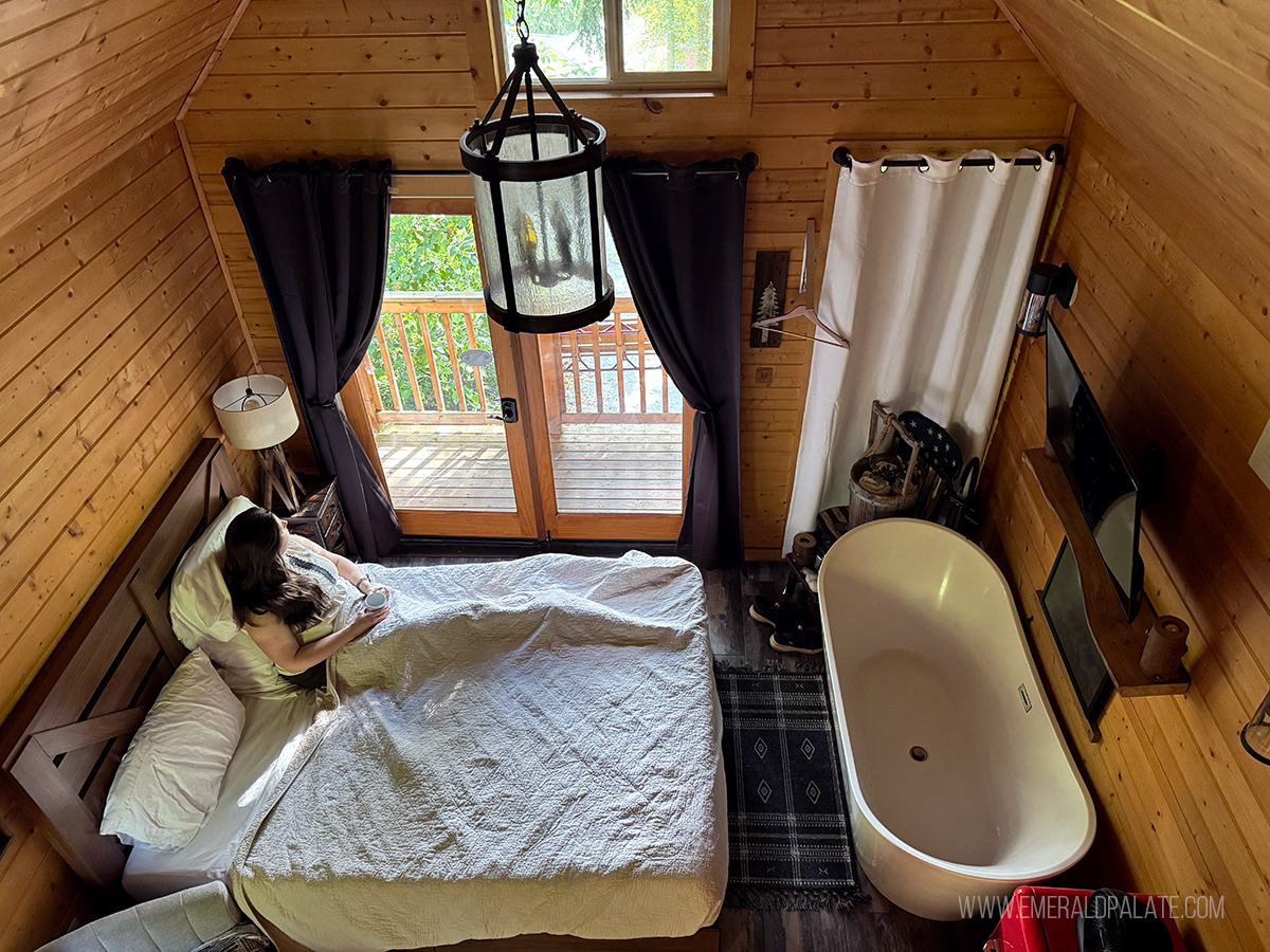 woman relaxing on a bed at Treehouse Point in Snohomish