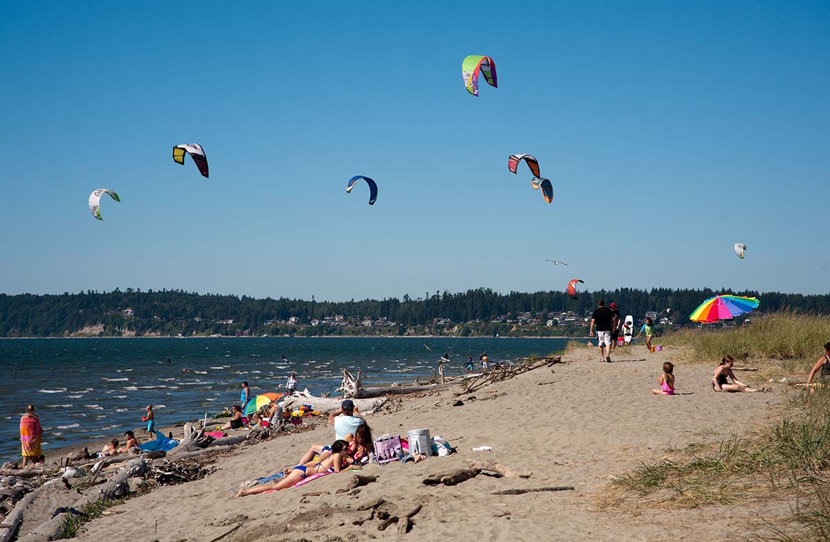 people flying kites on Jetty Island, one of the best things to do in Snohomish
