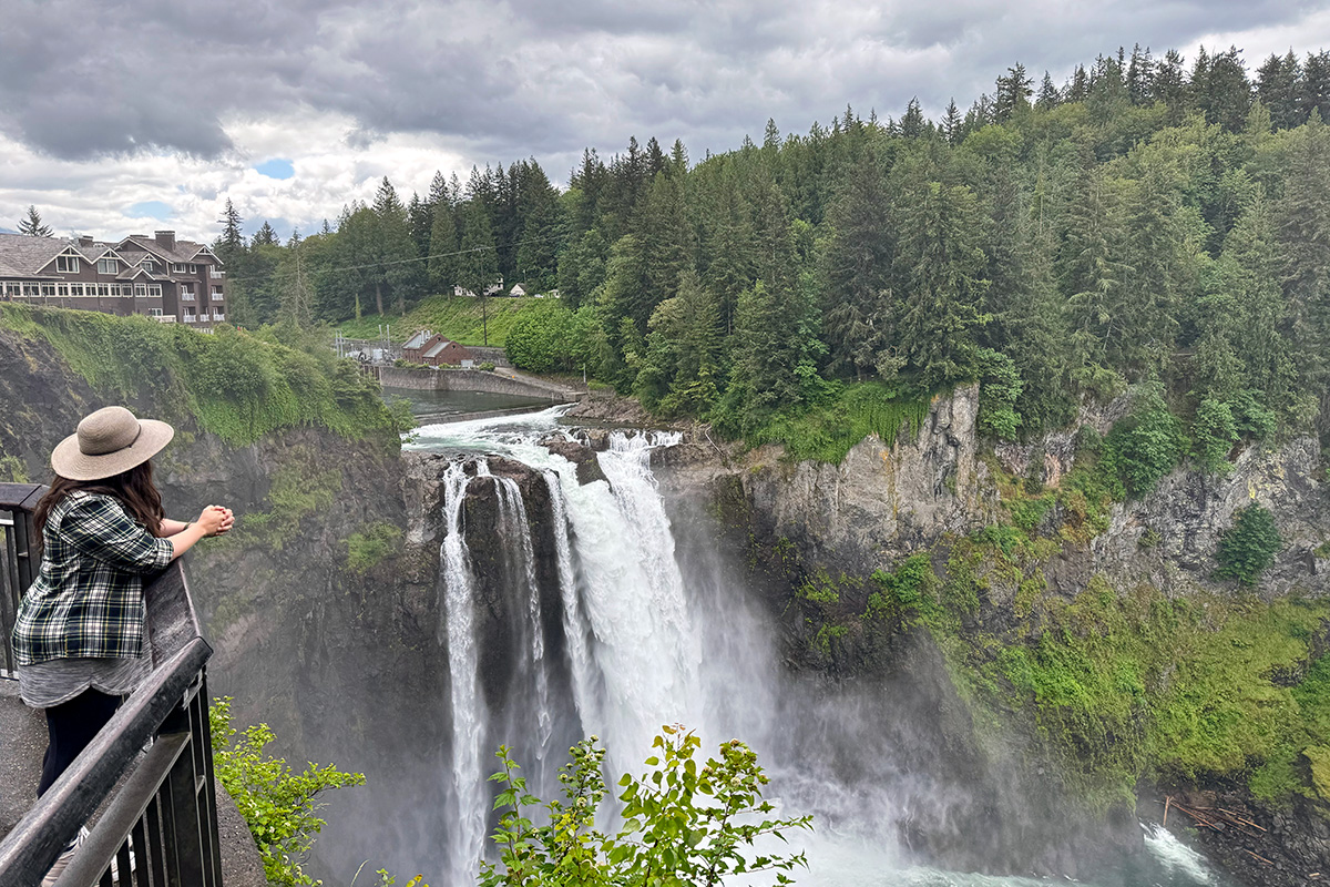 woman taking in the views at Snoqualmie Falls, one of the best things to do in Snoqualmie