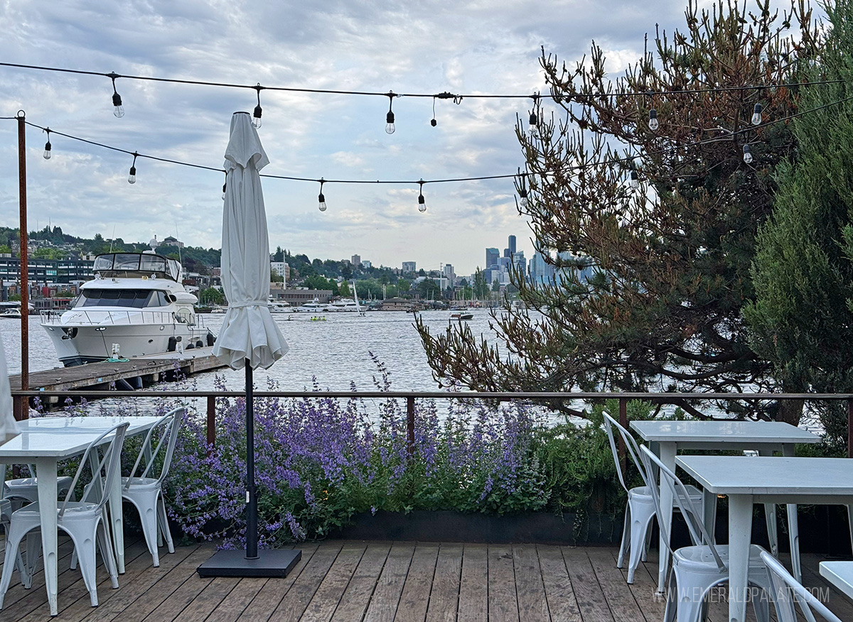 Best outdoor dining in Seattle patio overlooking Lake Union with boat and skyline in distance