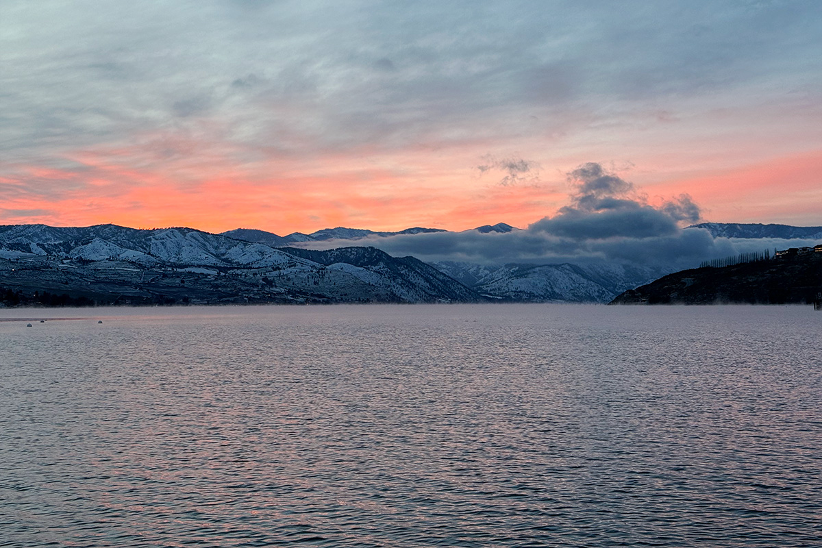 One of the best Washington state lakes, Lake Chelan, at sunset with mountains in the distance